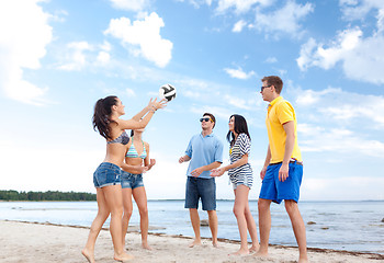 Image showing group of happy friends playing beach ball