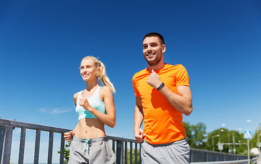 Image showing smiling couple running at summer seaside