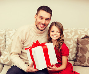 Image showing smiling father and daughter holding gift box