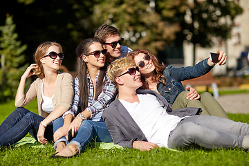 Image showing teenagers taking photo outside with smartphone