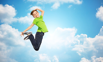 Image showing smiling boy jumping in air