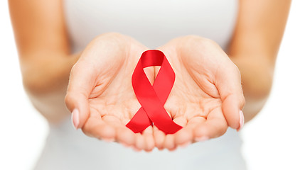 Image showing hands holding red AIDS awareness ribbon