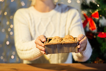 Image showing close up of woman with oat cookies at home