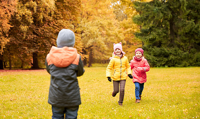 Image showing group of happy little kids running outdoors