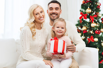 Image showing happy family at home with christmas gift box