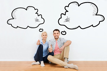 Image showing happy couple showing thumbs up at new home