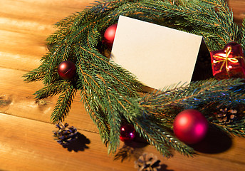 Image showing natural green fir wreath with note on wooden board