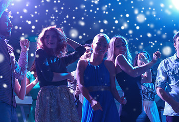 Image showing group of happy friends dancing in night club