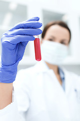 Image showing close up of scientist holding test tube in lab