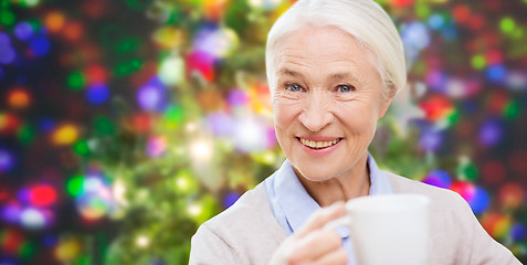 Image showing happy senior woman with cup of tea or coffee