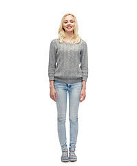 Image showing smiling young woman in gray pullover and jeans