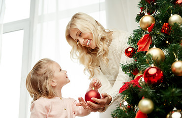 Image showing happy family decorating christmas tree at home