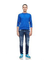 Image showing smiling young man in blue pullover and jeans