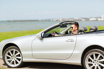 Image showing happy man driving cabriolet car outdoors