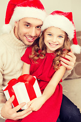 Image showing smiling father and daughter holding gift box