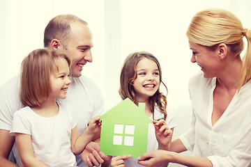 Image showing smiling parents and two little girls at new home