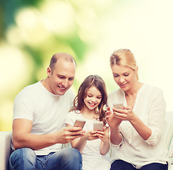 Image showing happy family with smartphones