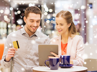 Image showing couple with tablet pc and credit card in mall