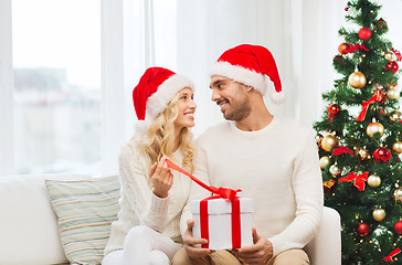 Image showing happy couple at home with christmas gift box