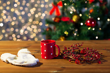 Image showing tea cup with mittens and christmas decoration