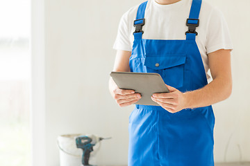 Image showing close up of builder or workman with tablet pc