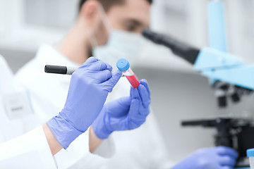 Image showing close up of scientists hands with test tube in lab