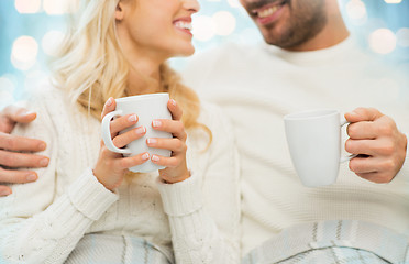 Image showing close up of happy couple with tea cups at home