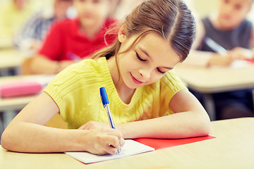 Image showing group of school kids writing test in classroom