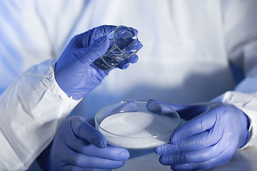 Image showing close up of scientists hands with chemicals in lab