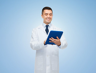 Image showing smiling male doctor in white coat with tablet pc
