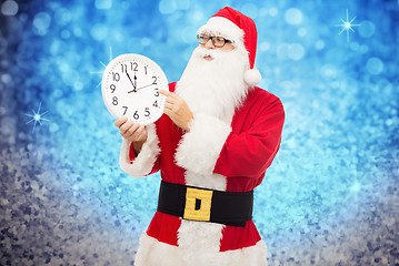 Image showing man in costume of santa claus with clock