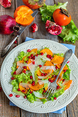 Image showing Vitamin salad with persimmon, cheese and pomegranate seeds.