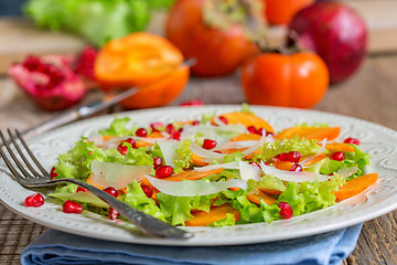 Image showing Delicious salad with persimmon. Healthy food.