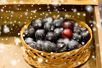 Image showing ripe plums in basket at farm or food market