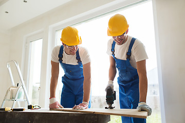 Image showing group of builders with tools indoors