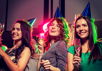 Image showing smiling friends with glasses of champagne in club