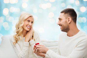 Image showing happy man giving engagement ring to woman