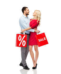 Image showing happy couple with red shopping bags