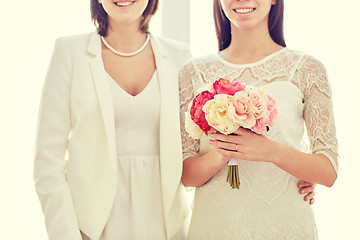 Image showing close up of happy lesbian couple with flowers