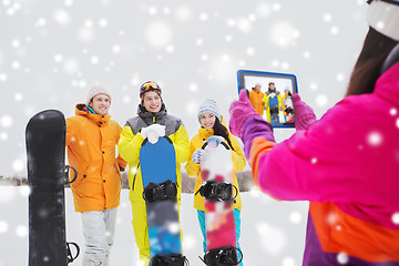 Image showing happy friends with snowboards and tablet pc