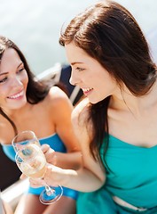 Image showing girls with champagne glasses on boat