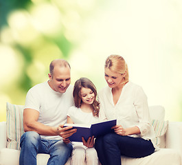 Image showing happy family with book at home