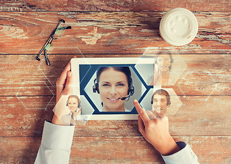 Image showing close up of hands with tablet pc and helpline