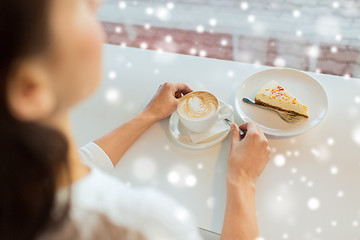 Image showing close up of woman hands with cake and coffee