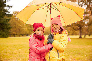 Image showing happy little girls with umbrella in autumn park