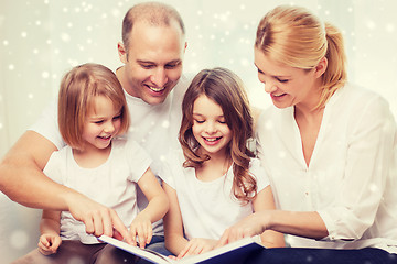 Image showing happy family with book at home