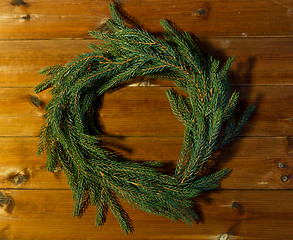 Image showing natural green fir branch wreath on wooden board