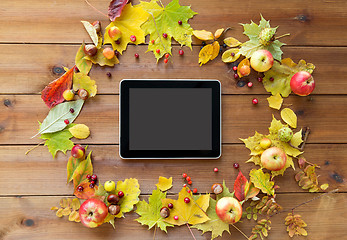 Image showing tablet pc with autumn leaves, fruits and berries