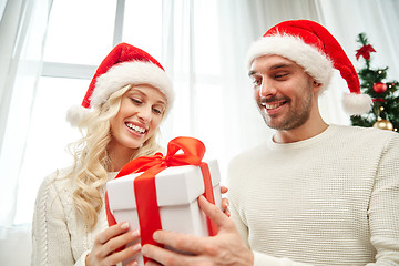 Image showing happy couple at home with christmas gift box