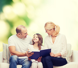 Image showing happy family with book at home